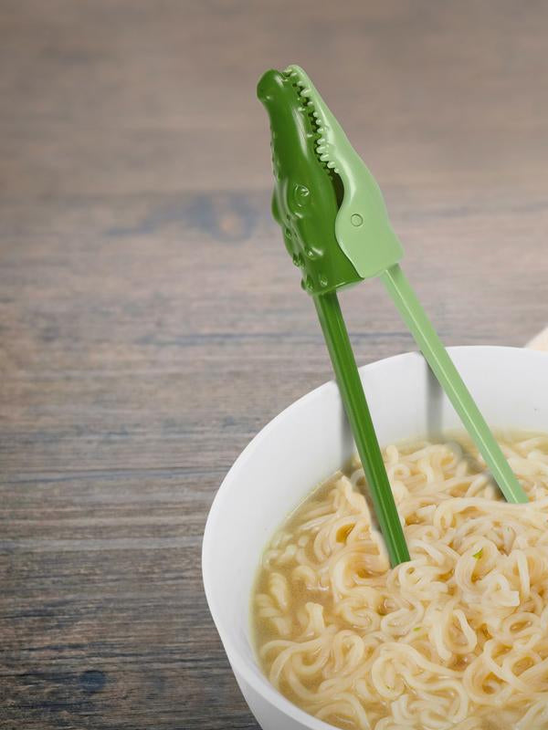 Pair of chopsticks designed to look like crocodile heads, with detailed textures and a playful, quirky design that adds fun to mealtime.