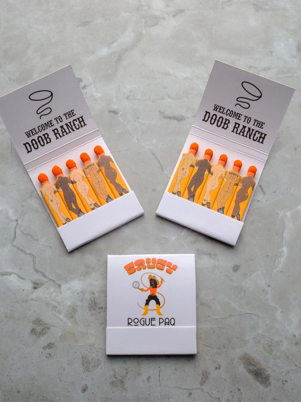 A matchbook from Doob Ranch, featuring a playful and rustic design on the cover. The matchbook contains several matchsticks and adds a touch of personality with its unique branding, perfect for lighting candles or creating a fun conversation piece.
