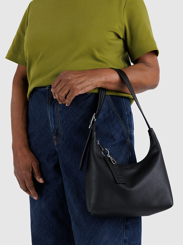 A compact black shoulder bag made from recycled leather, featuring a sleek design with an adjustable strap, offering an eco-friendly and stylish accessory for everyday use.