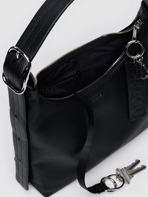 A compact black shoulder bag made from recycled leather, featuring a sleek design with an adjustable strap, offering an eco-friendly and stylish accessory for everyday use.