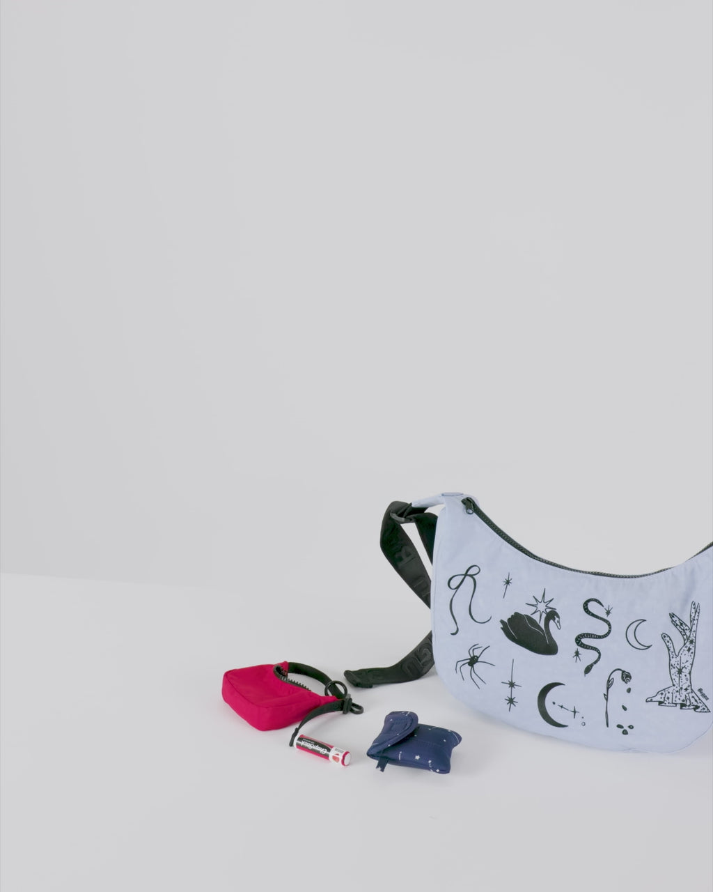 Crescent Bag Charm by Baggu, a playful and stylish accessory featuring a crescent-shaped design, perfect for adding a fun touch to your bag or keychain.