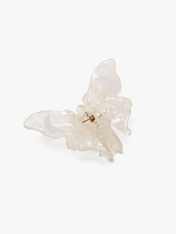 A delicate white satin moth claw, showcasing its intricate, fine details and soft, satin-like texture. The claw is small and elegantly curved, with a slightly translucent appearance, typical of moths' unique anatomy.