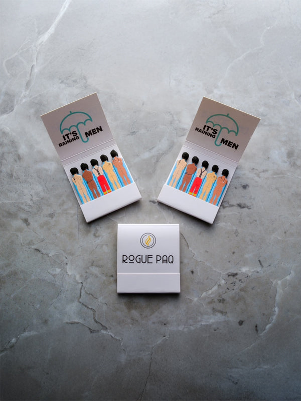 A compact matchbook with the playful slogan 'Send Dudes' printed on the cover. The design features bold, simple typography on a colorful background, with a classic matchbook format containing several matchsticks.