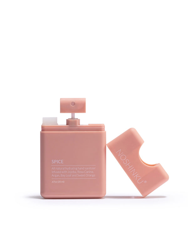 Pocket sanitizer in a refreshing orange and coriander scent, featuring a compact bottle that's perfect for on-the-go cleansing and a burst of fresh fragrance.