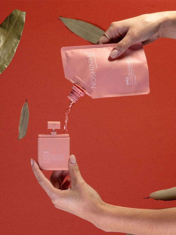 Pocket sanitizer in a refreshing orange and coriander scent, featuring a compact bottle that's perfect for on-the-go cleansing and a burst of fresh fragrance.