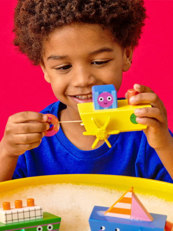 Wind-up boat toy featuring a playful design that moves across water when wound up, perfect for fun bath time or imaginative play.